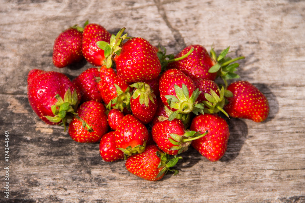Ripe fresh strawberries on rustic wooden background. Top view