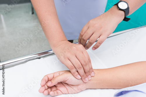 Nurse's Hand feel for the pulse of the people who are unconscious. Radial Pulse Assessment.