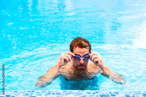 Man swimming in an indoor swimming pool.