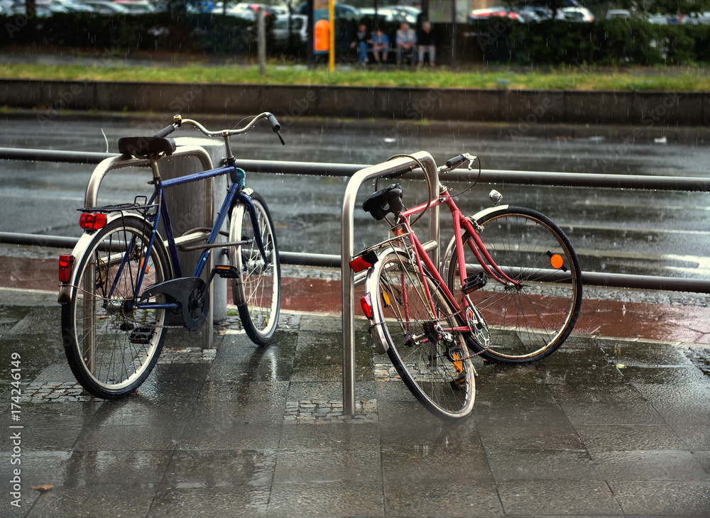 bicycles on wet Berlin city street in rain. Rainy day