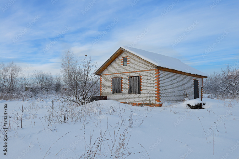 unfinished brick house on a snow-covered area in winter unfinished brick house on a snow-covered area in winter