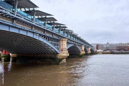 LONDON CITY - DECEMBER 24, 2016: Blackfriars Bridge with the wide arch construction and the roof covering, crossing the river Thames