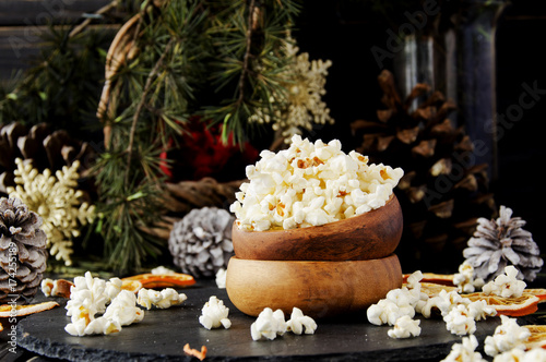 popcorn in a wooden plate on the background of Christmas