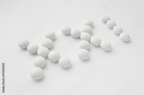 White pills on white background, the twenty-first century