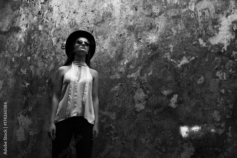 A girl in a white blouse, with tare destroyed building. Helouin. Black and white photo A girl in a white blouse, with tare destroyed building. Helouin. Black and white photo