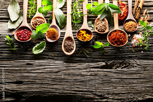 Herbs and spices on a old wooden background