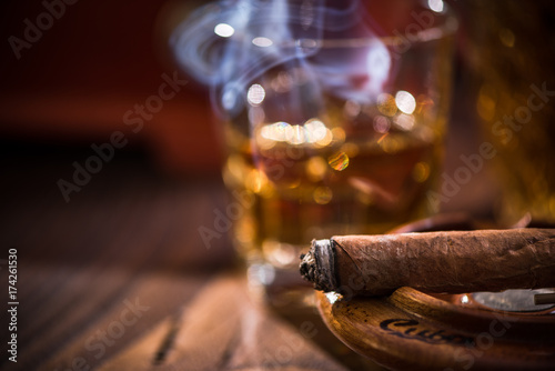 Smoking cigar in vintage ashtray