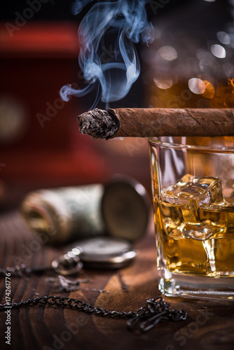 Smoke from Cuban Cigar and luxurious items in background © marcin jucha