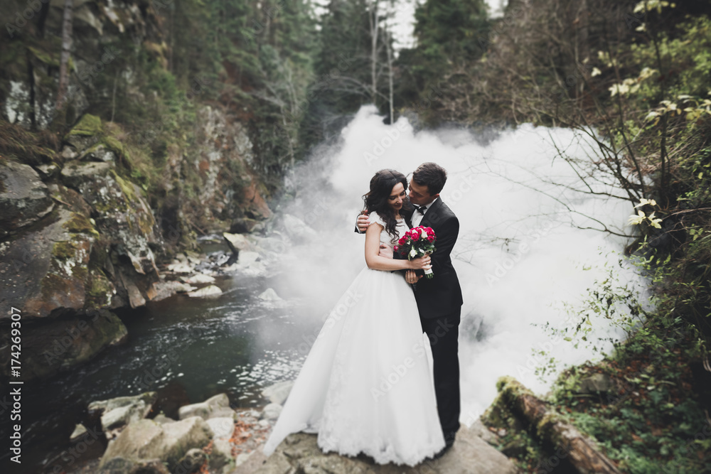 Beautiful gorgeous bride posing to groom and having fun, luxury ceremony at mountains with amazing view, space for text, wedding couple Beautiful gorgeous bride posing to groom and having fun, luxury ceremony at mountains with amazing view, space for text, wedding couple