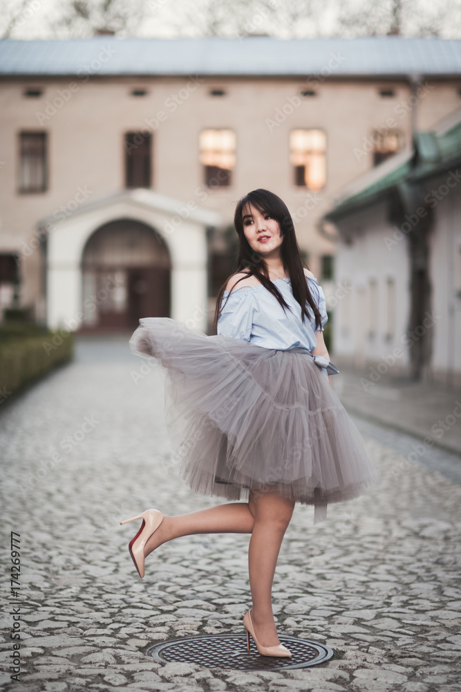 Young Asians girl with modern dress posing in an old Krakow Young Asians girl with modern dress posing in an old Krakow