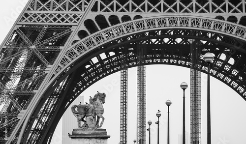 Canvas Print Eiffel tower, statue of the horse, streetlights and Montparnasse building at background
