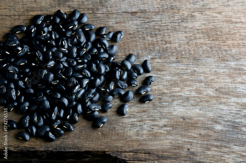 a lot of black bean on wood background for health