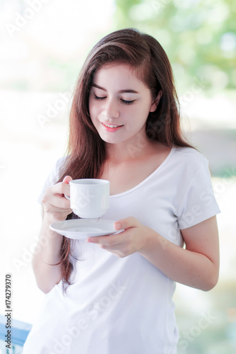 young woman enjoy drinking coffee outdoor on balcony