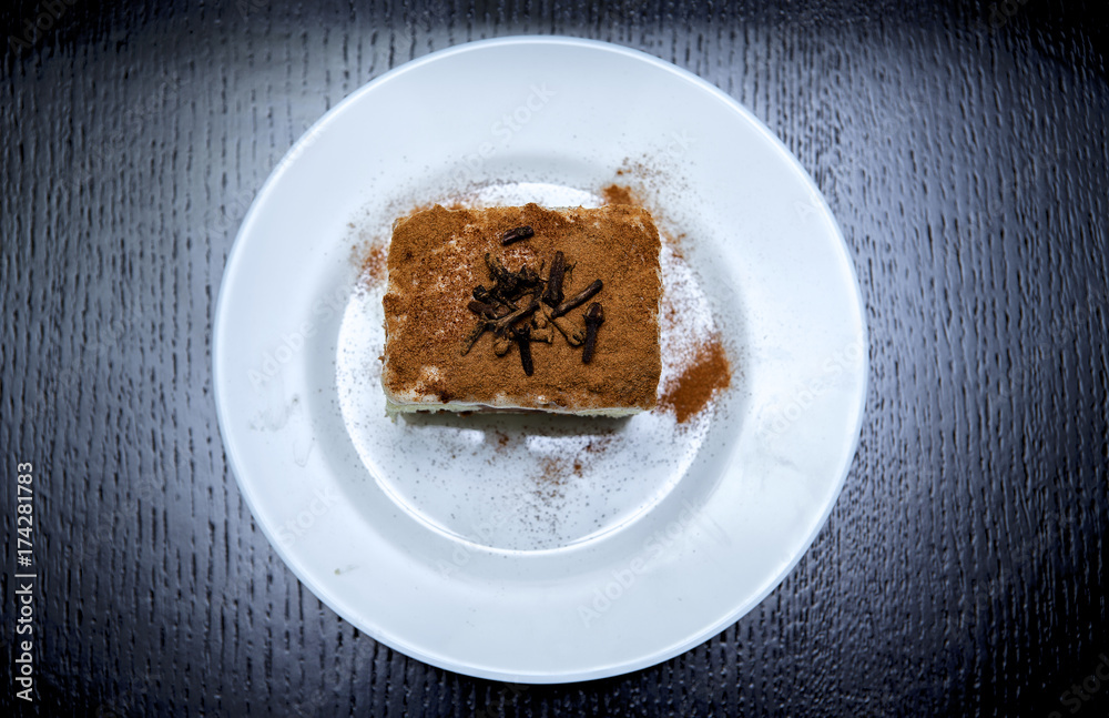piece of cake on a plate on a dark background piece of cake on a plate on a dark background