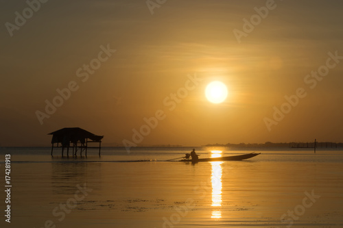 Fishermen and fishing boats float in the lake.