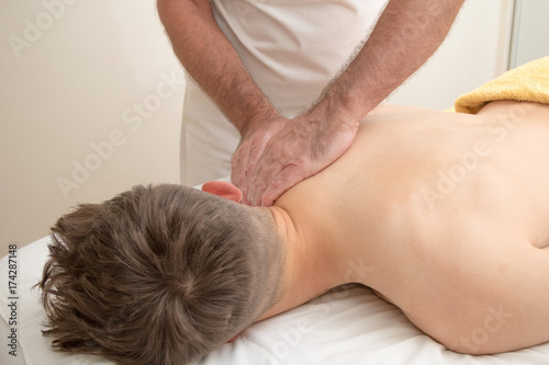 Teenage boy laying on a massage table
