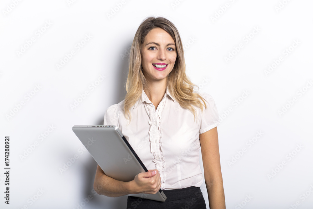 Young business woman offers computer product, on grey background Young business woman offers computer product, on grey background