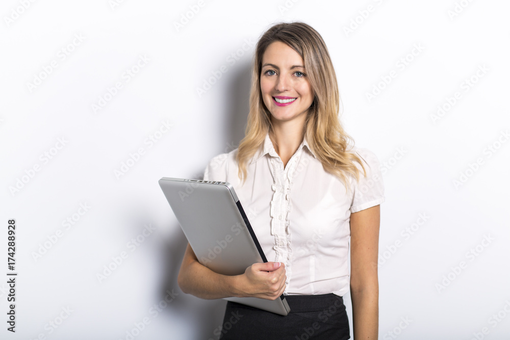 Young business woman offers computer product, on grey background Young business woman offers computer product, on grey background