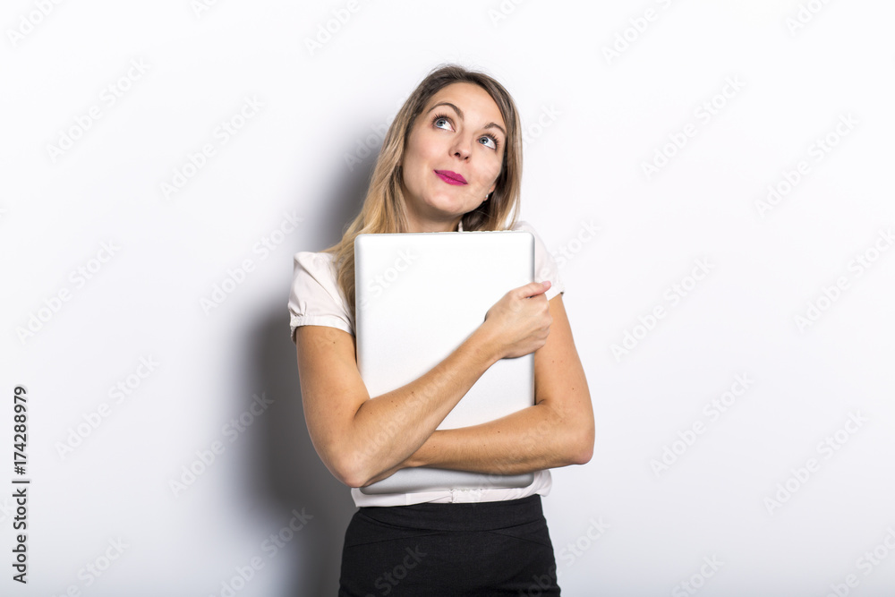 Young business woman offers computer product, on grey background Young business woman offers computer product, on grey background