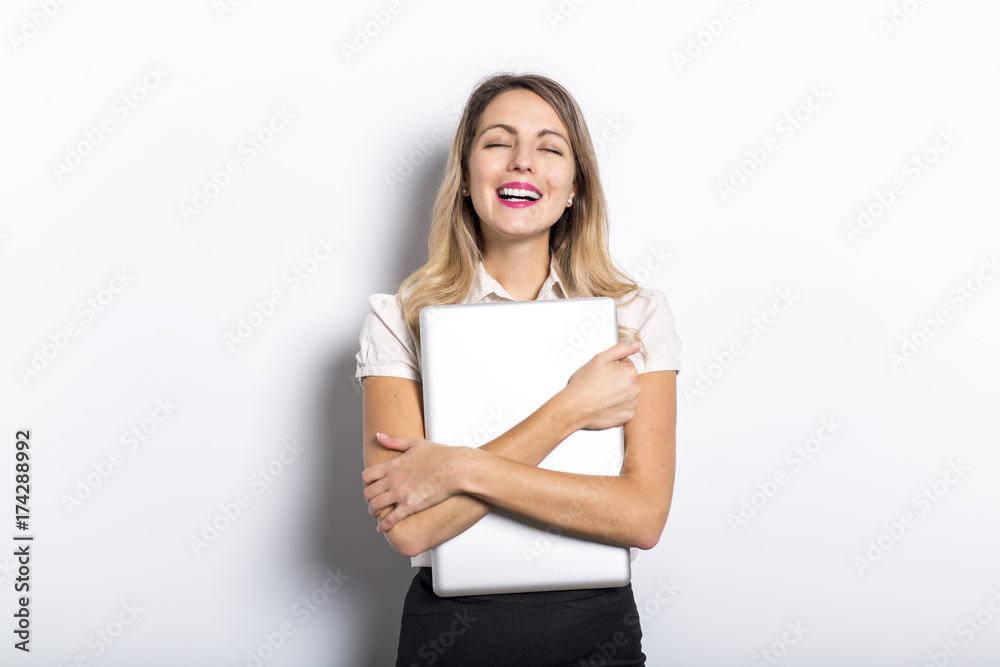 Young business woman offers computer product, on grey background Young business woman offers computer product, on grey background