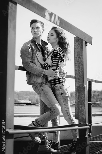 Young beautiful fashion couple wearing jeans clothes in daylight