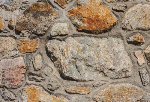 concrete and stone wall / detail of a containment wall made of concrete and stone with photo