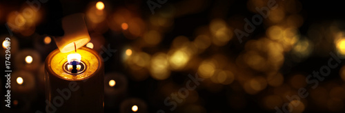 Light candle with golden bokeh photo