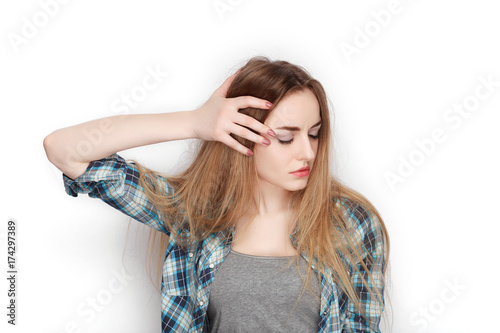 Beauty portrait of young adorable fresh looking blonde woman in blue plaid shirt. Emotion and facial expression concept.