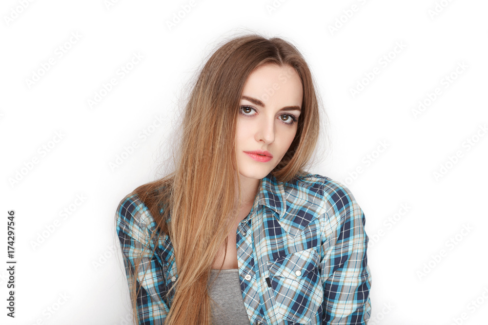 Beauty portrait of young adorable fresh looking blonde woman in blue plaid shirt. Emotion and facial expression concept. Beauty portrait of young adorable fresh looking blonde woman in blue plaid shirt. Emotion and facial expression concept.