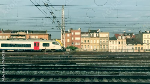 Train passes by slowly from left to right. Camera moving on same direction as passes train. 