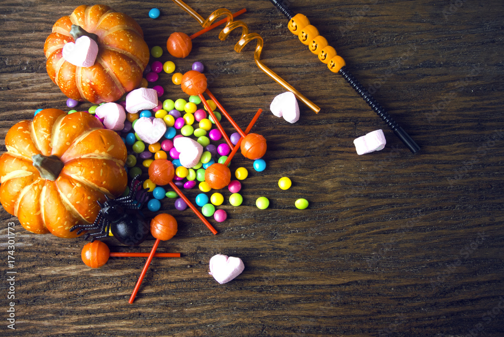 colorful of halloween candy with dessert on wood ground in party concept colorful of halloween candy with dessert on wood ground in party concept