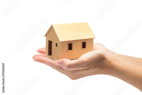 hand with wood house