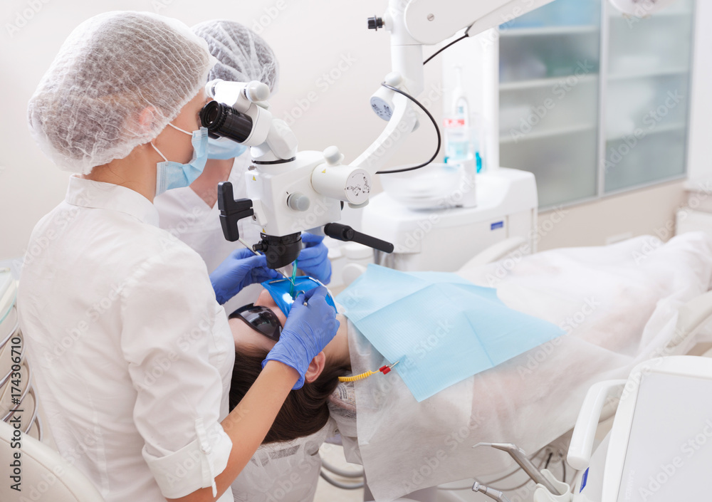 professional dentist examination patient with microscope at the office professional dentist examination patient with microscope at the office