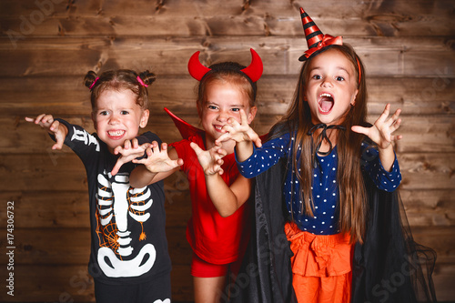 holiday halloween. Funny group children in carnival costumes on a wooden
