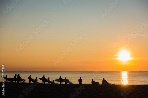 French sunset lifeguard surfers line up to go and train, Hossegor, France