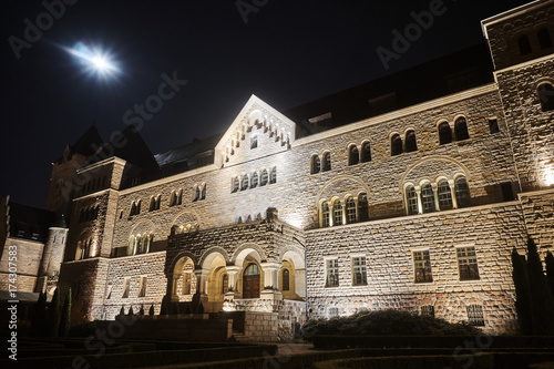 emperors castle and moon in night in Poznan, Poland .
