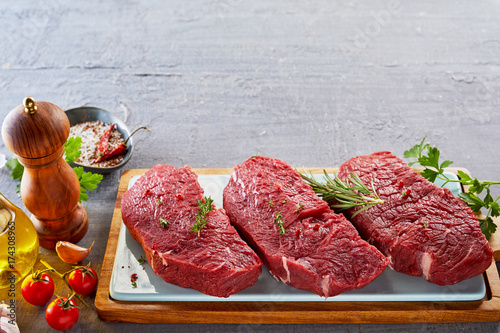 Rump steak with spices on cutting board
