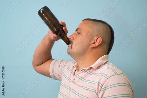 The man drinks beer