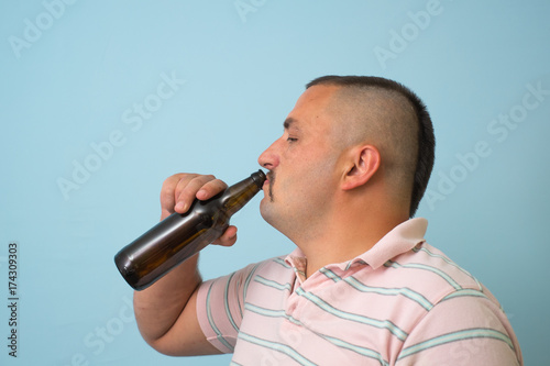 The man drinks beer
