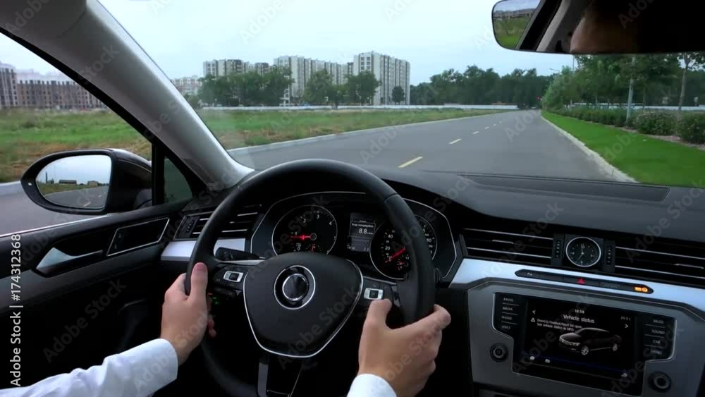 the man uses the multifunction in the car. the man uses the multifunction in the car.