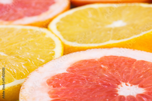 Fototapeta Naklejka Na Ścianę i Meble -  Colorful fruit pattern of fresh lemon and grapefruit slices as background angle view