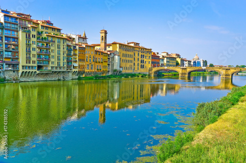 View of the Old Bridge across the Arno River in Florence on a sunny day