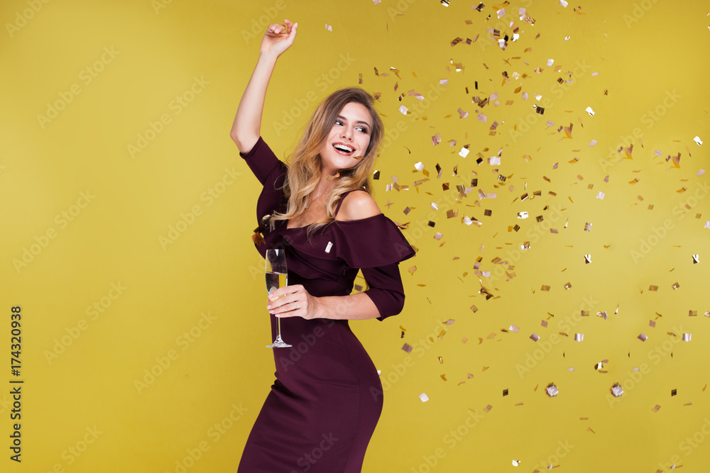 Happy New Year to you. One young and beautiful woman dancing with glass of champagne and smiling. Girl is happy about the New Year Happy New Year to you. One young and beautiful woman dancing with glass of champagne and smiling. Girl is happy about the New Year
