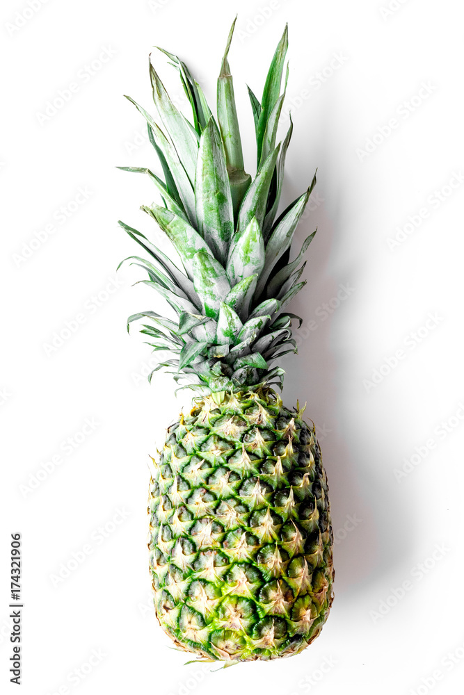 Tropical fruits background. Pinneapple on white top view Tropical fruits background. Pinneapple on white top view