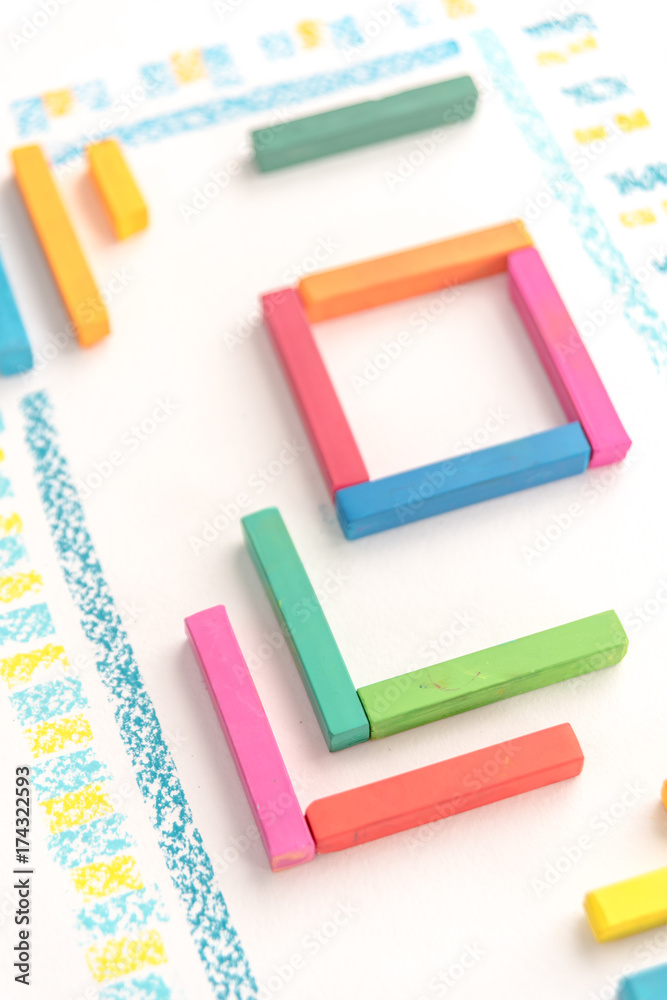 Cropped photo of a cute geometric pattern made of colorful kid's pastel chalks Cropped photo of a cute geometric pattern made of colorful kid's pastel chalks