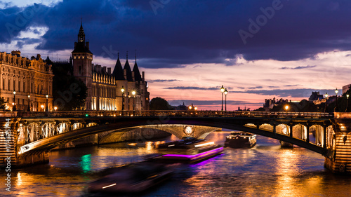 Night view of Conciergerie Castle and Pont Notre-Dame bridge over river Seine. Paris, France © Aliaksandr Kazlou