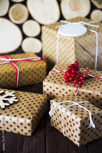 New Year and Christmas gifts packed and decorated on a wooden table