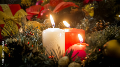 Beautiful winter holiday background with Advent wreath and burning Christmas candles