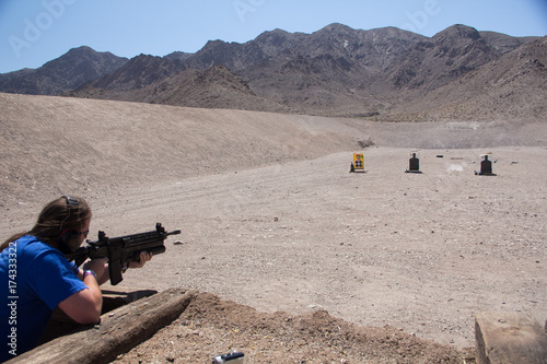 Firing an AR-15 assault rifle with grenade launcher on a shooting range in the desert of Nevada, USA