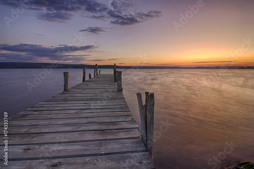 Fototapeta Naklejka Na Ścianę i Meble -  Beauty and calm sunset on lake with wooden pier